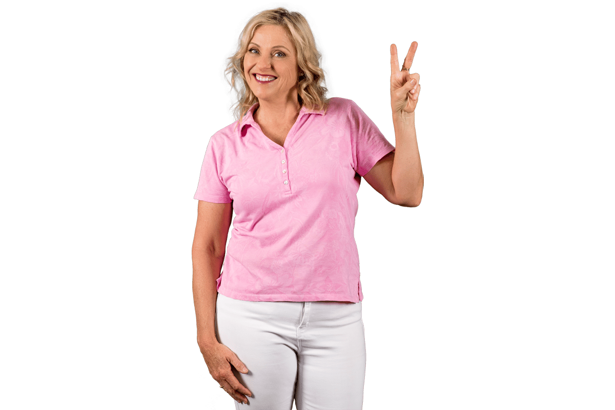 Paula Nutting, Your musculoskeletal specialist, wearing a pink blouse and white pants smiling with a peace sign pose