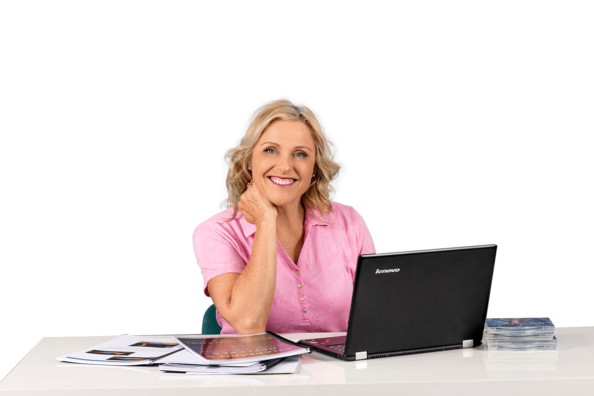Paula Nutting, Your musculoskeletal specialist, wearing a pink blouse smiling with a Lenovo black laptop