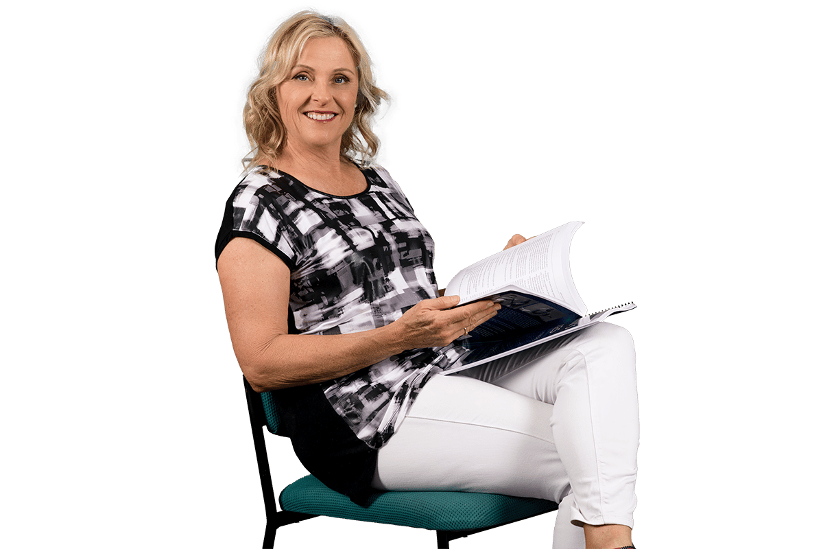 Paula Nutting, your musculoskeletal specialist sitting and smiling