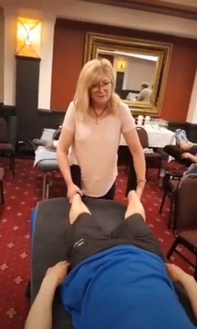 Paula Nutting, your musculoskeletal specialist stretching a patient