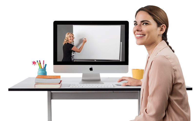 woman sitting and smiling in front of an Apple iMac desktop computer watching Paula Nutting teach